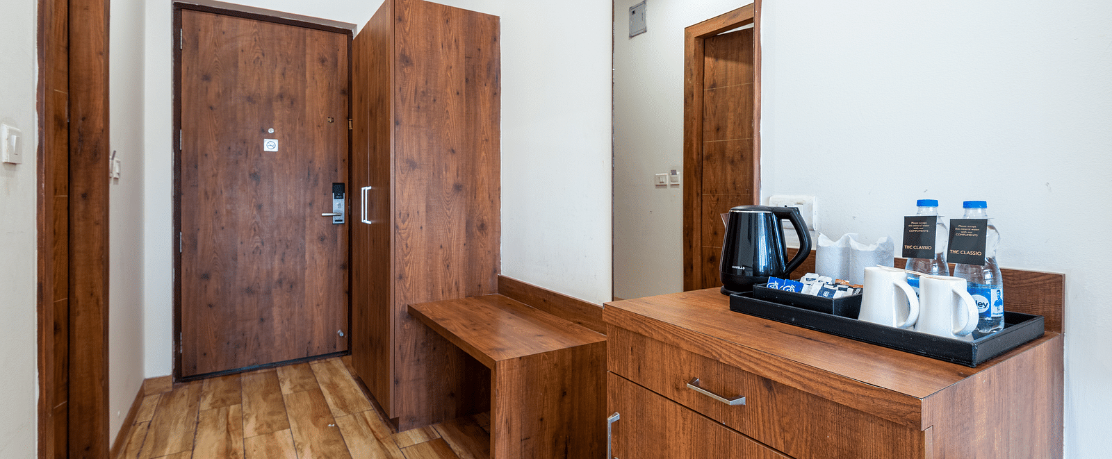 premium room with tea & coffee maker and a wooden wardrobe at DLS The Classio